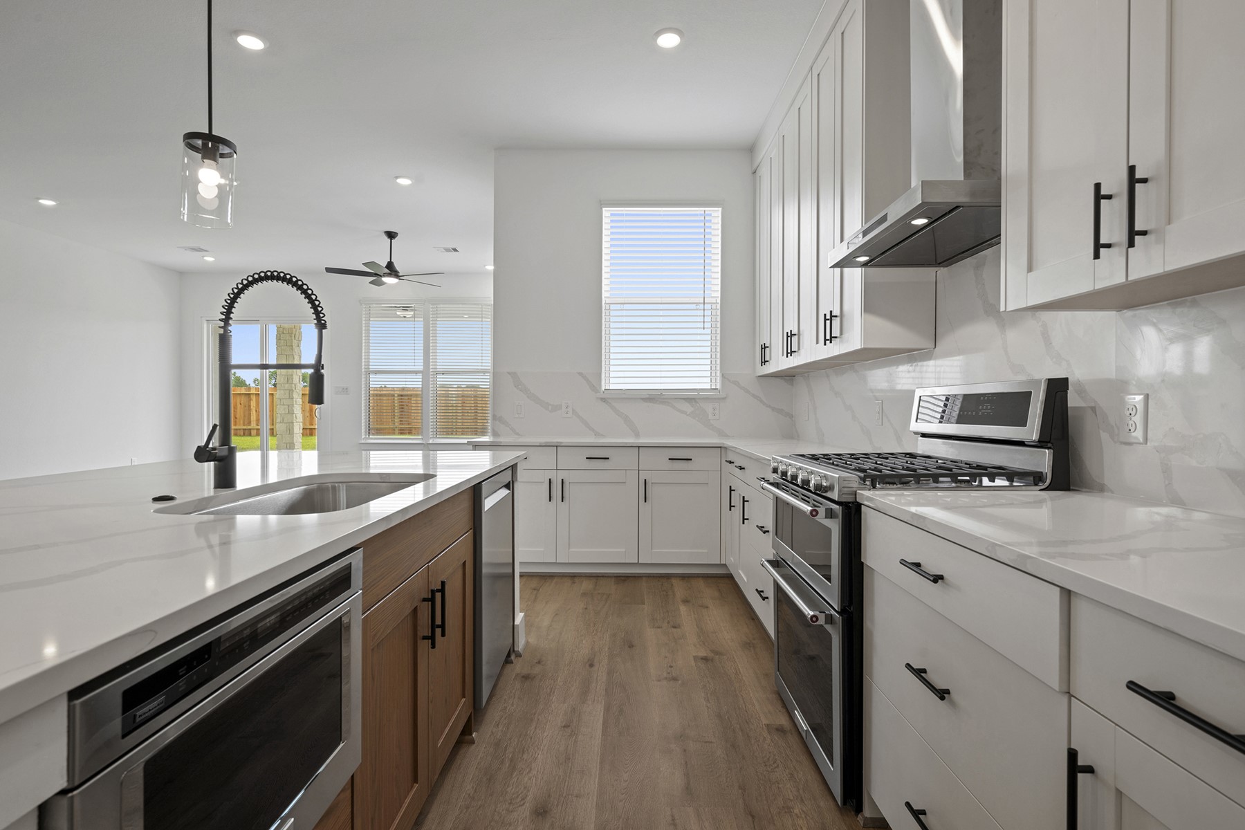 1805 Drover Lane Rosenberg, TX 77471 - Photo 11 of 29 a kitchen with stainless steel appliances granite countertop a sink a stove and cabinets