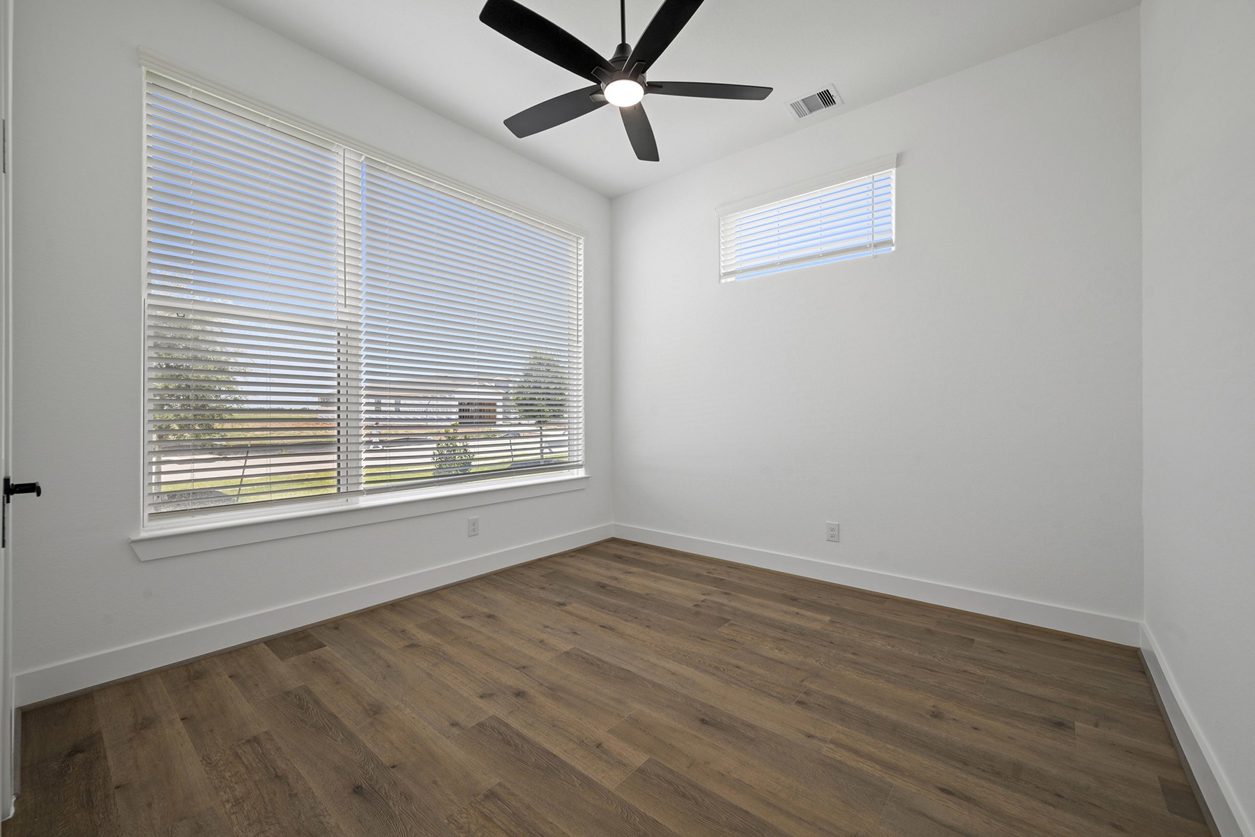 1805 Drover Lane Rosenberg, TX 77471 - Photo 17 of 29 a view of an empty room with wooden floor and a window