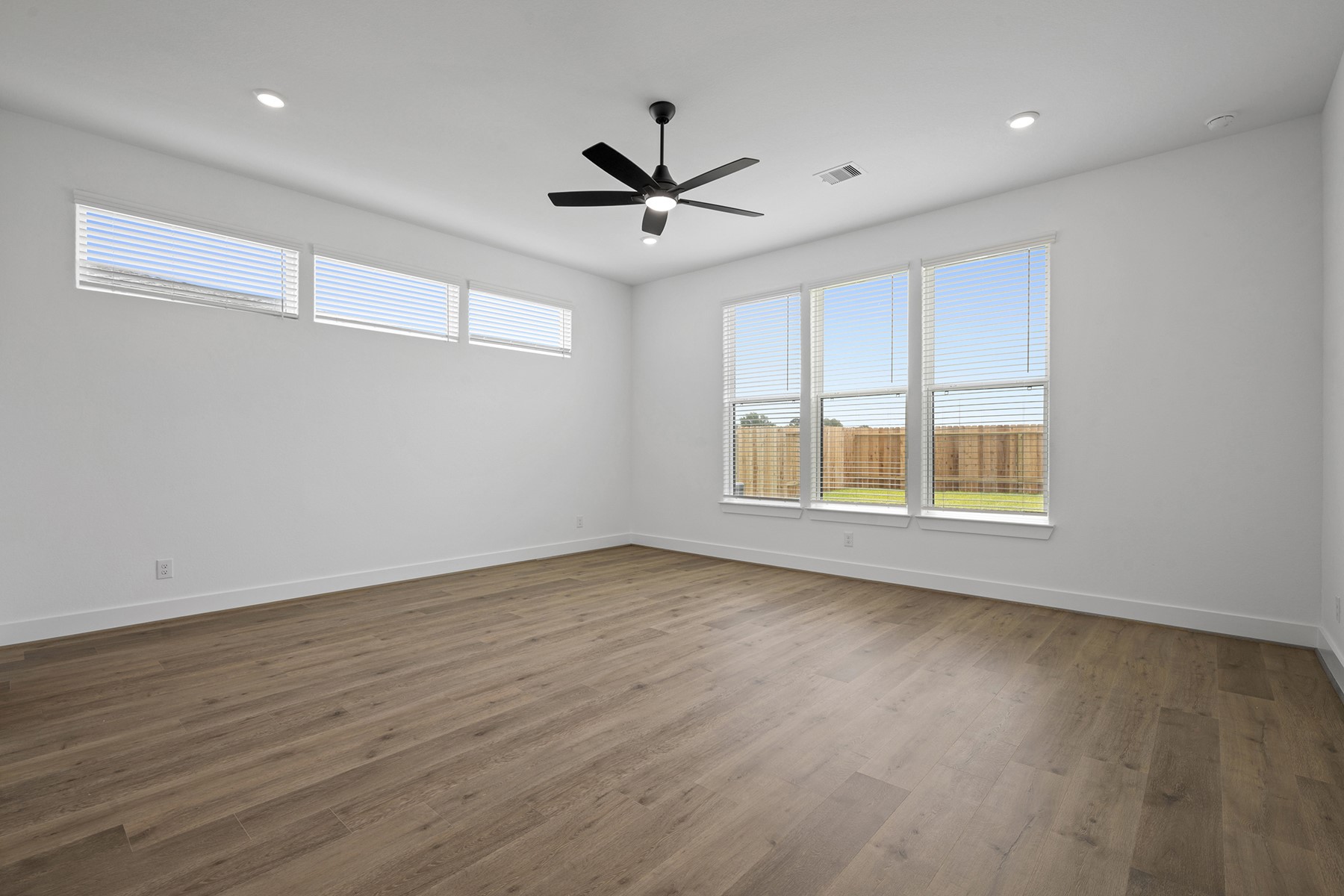 1805 Drover Lane Rosenberg, TX 77471 - Photo 19 of 29 a view of an empty room with wooden floor and a window