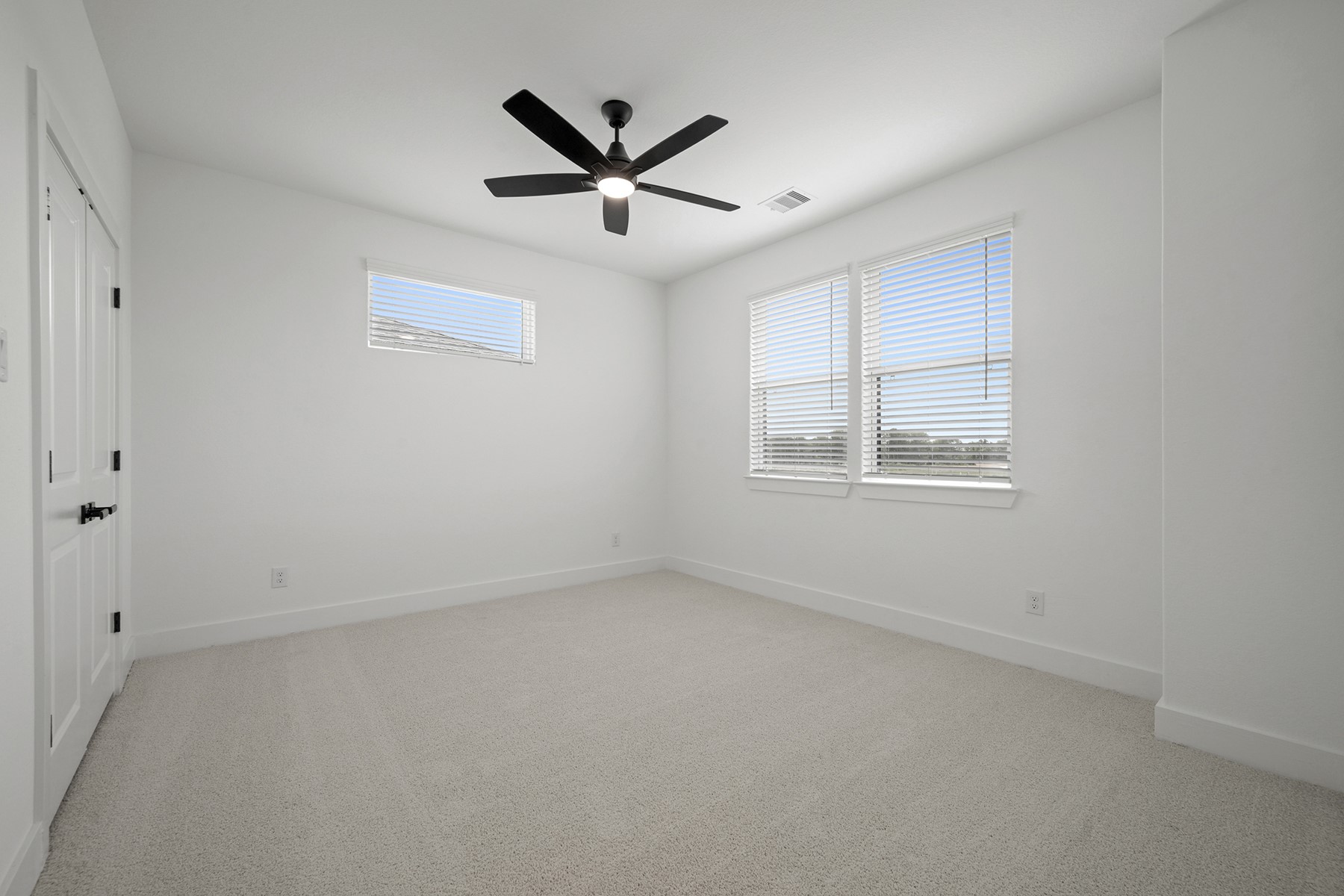 1805 Drover Lane Rosenberg, TX 77471 - Photo 24 of 29 an empty room with windows and fan