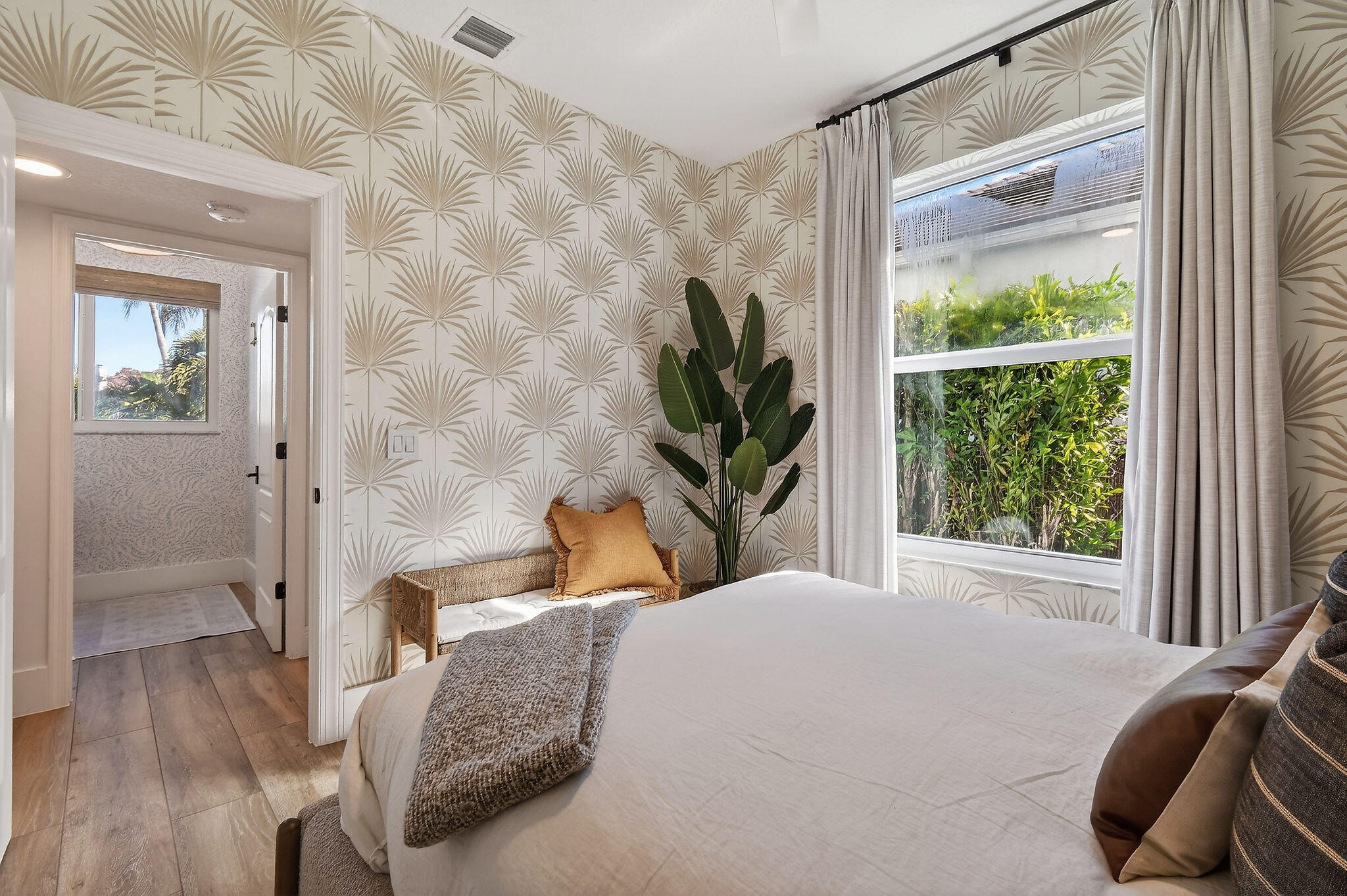 19954 Loxahatchee Pointe Drive Jupiter, FL 33458 - Photo 17 of 60 a bedroom with a bed flat screen tv and a large window