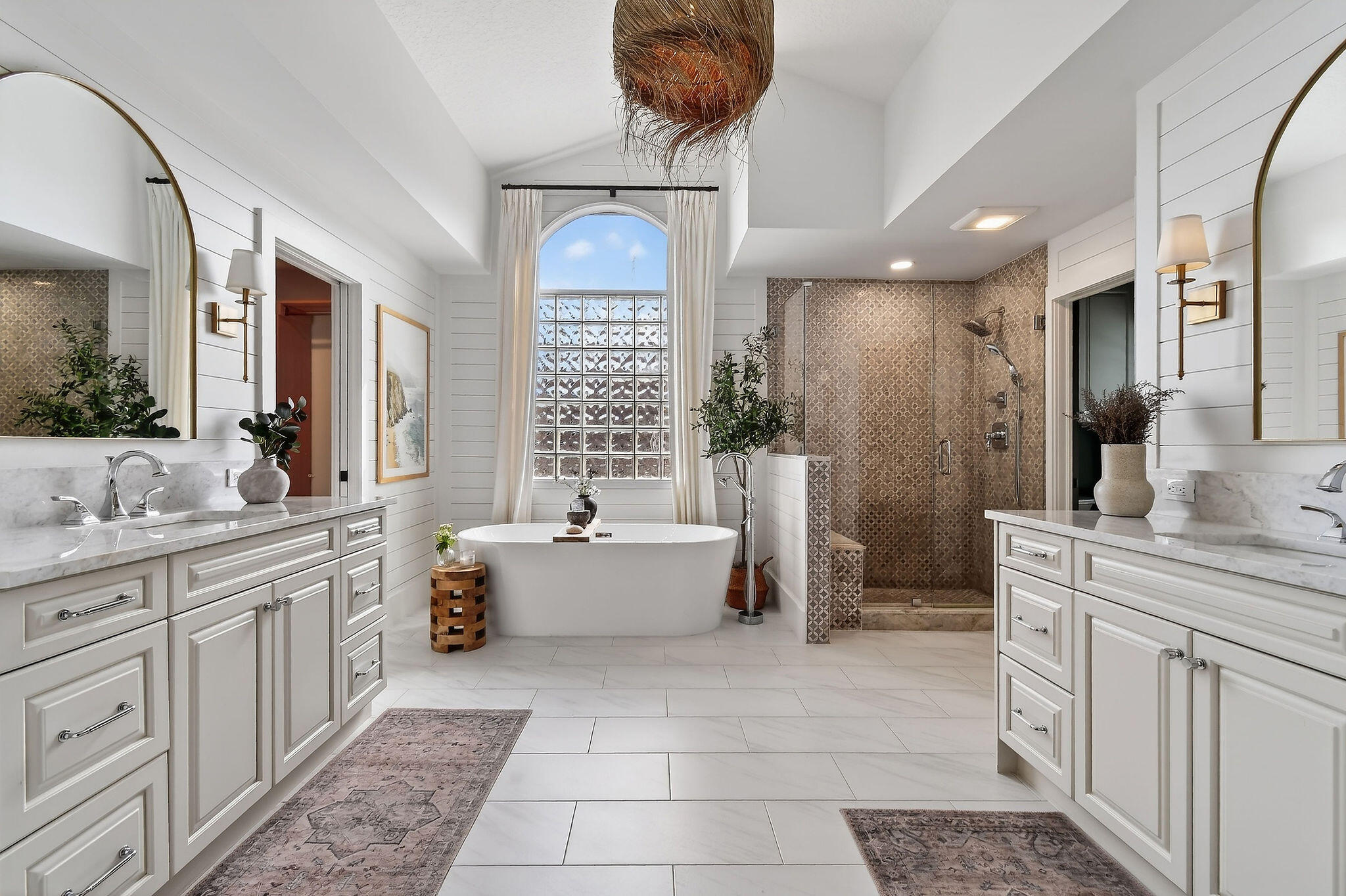 19954 Loxahatchee Pointe Drive Jupiter, FL 33458 - Photo 27 of 60 a bathroom with a double vanity sink a bathtub and next to a window