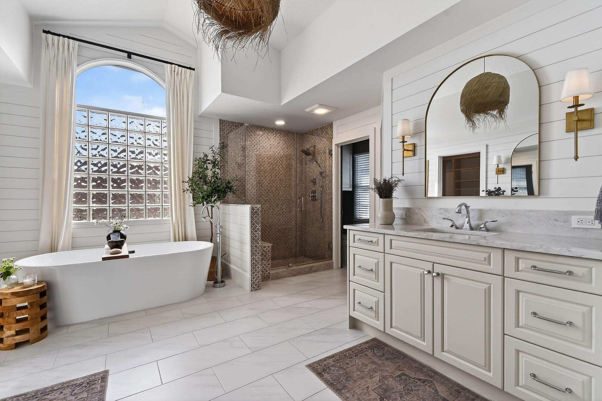 19954 Loxahatchee Pointe Drive Jupiter, FL 33458 - Photo 28 of 60 a spacious bathroom with a granite countertop sink a mirror a bathtub and next to a window