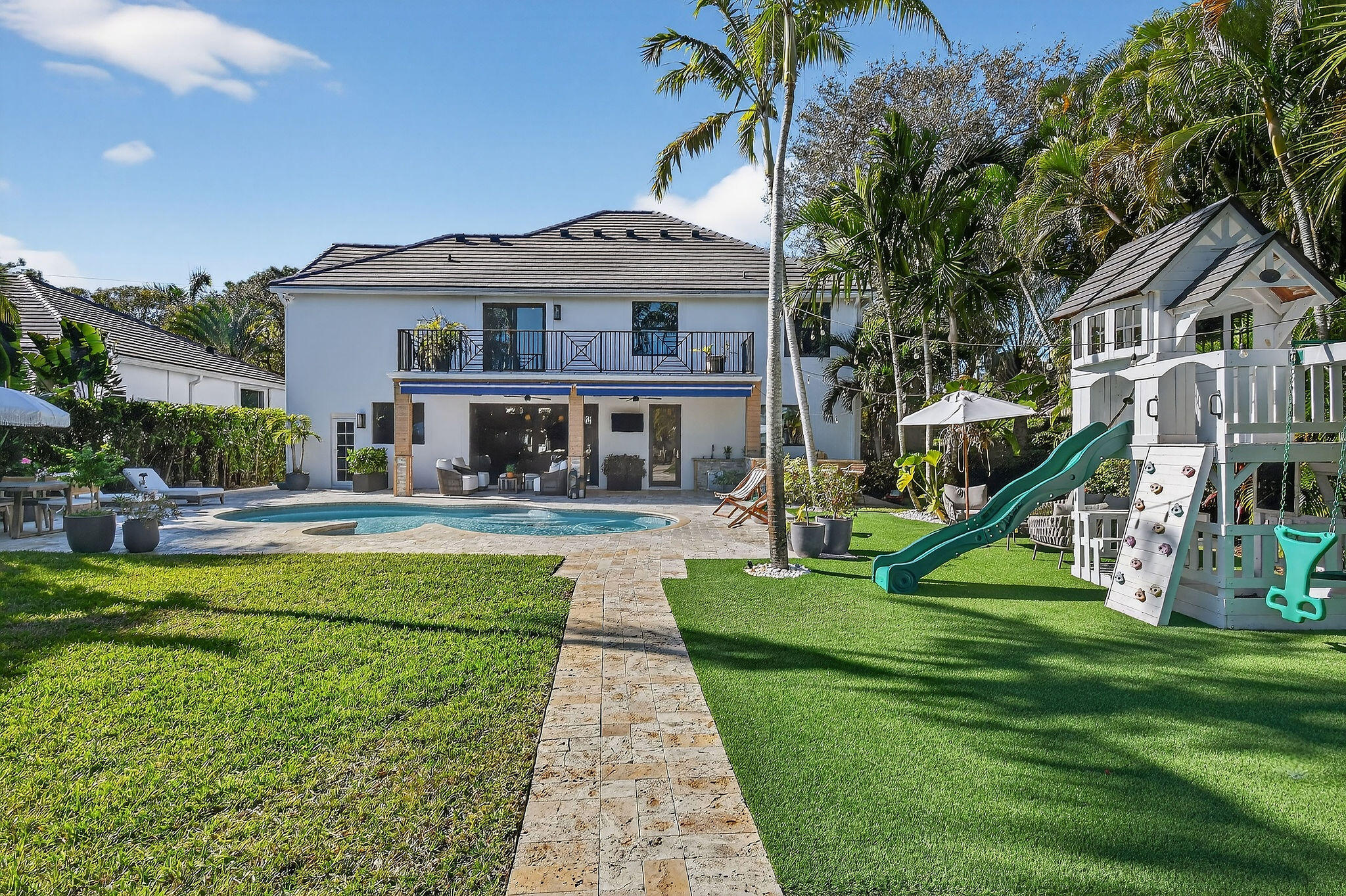 19954 Loxahatchee Pointe Drive Jupiter, FL 33458 - Photo 48 of 60 a front view of a house with a yard table and chairs