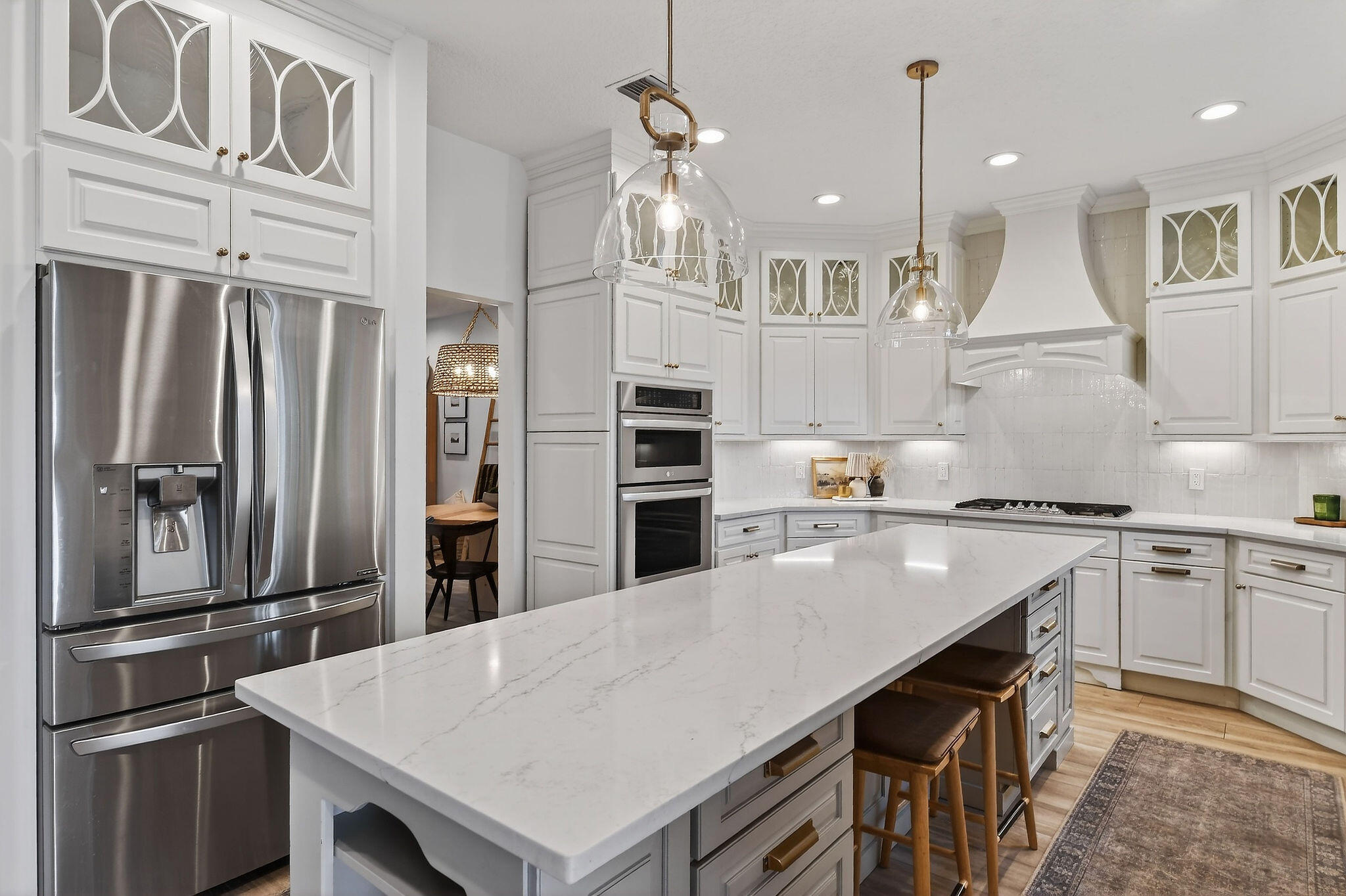 19954 Loxahatchee Pointe Drive Jupiter, FL 33458 - Photo 10 of 60 a kitchen with kitchen island a stove a sink and a refrigerator