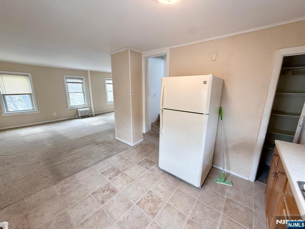 54 College Place Ridgefield Park, NJ 07660 - Photo 11 of 18 a view of a kitchen with refrigerator and hallway