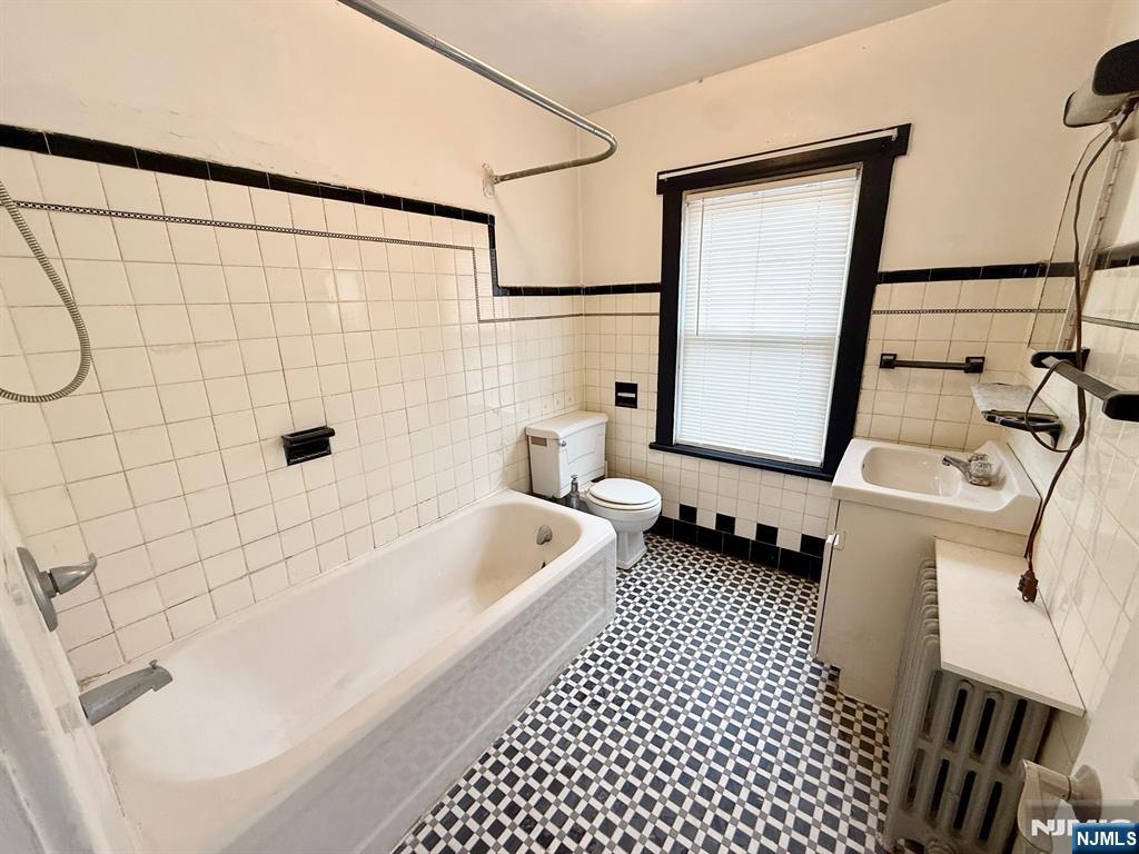 54 College Place Ridgefield Park, NJ 07660 - Photo 12 of 18 a bathroom with a bathtub and a shower