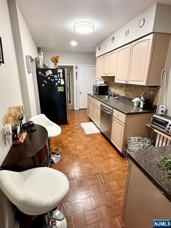 54 College Place Ridgefield Park, NJ 07660 - Photo 3 of 18 a kitchen with stainless steel appliances kitchen island granite countertop a sink dishwasher and a refrigerator