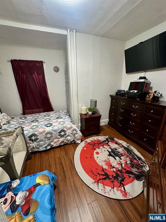 54 College Place Ridgefield Park, NJ 07660 - Photo 8 of 18 a bedroom with a bed and a flat screen tv