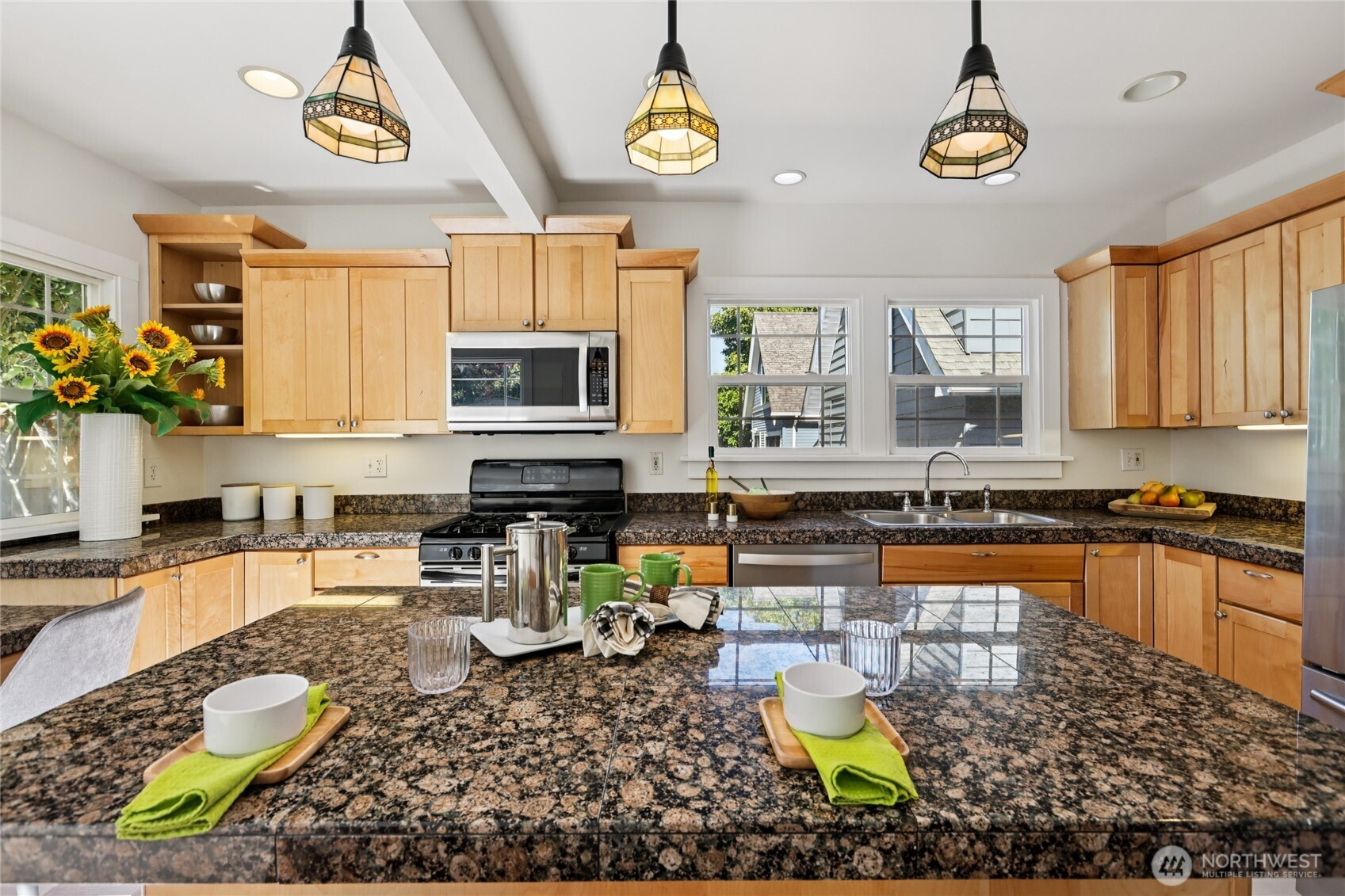511 23rd Avenue East Seattle, WA 98112 - Photo 13 of 39 a kitchen with a stove a sink and a microwave