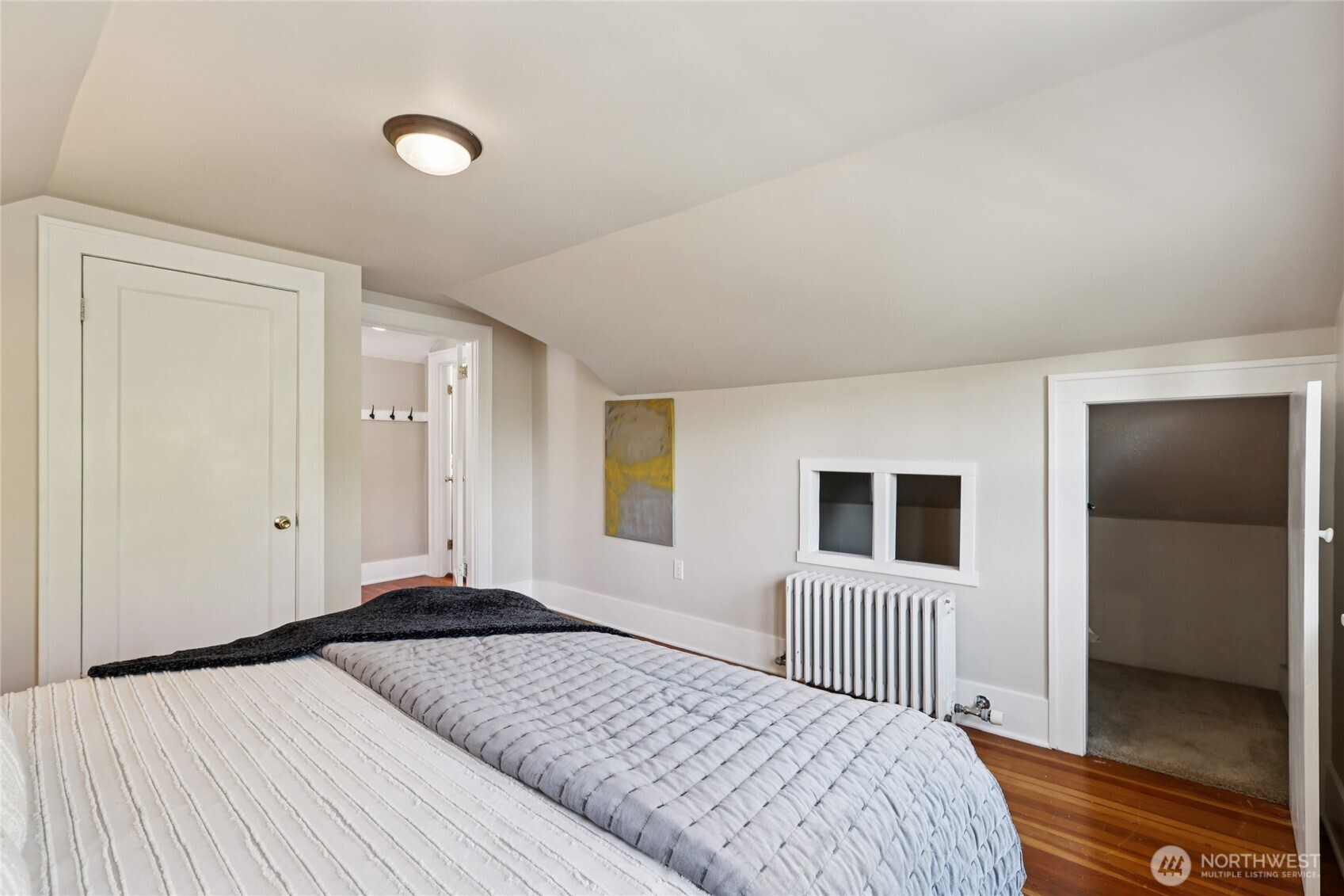511 23rd Avenue East Seattle, WA 98112 - Photo 22 of 39 a bedroom with a large bed and wooden floor