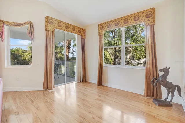 a kitchen with kitchen island granite countertop a stove a sink a dining table and chairs