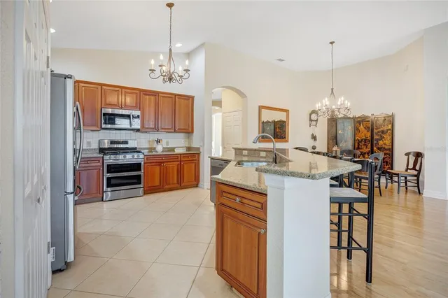 a kitchen with stainless steel appliances a refrigerator sink and cabinets