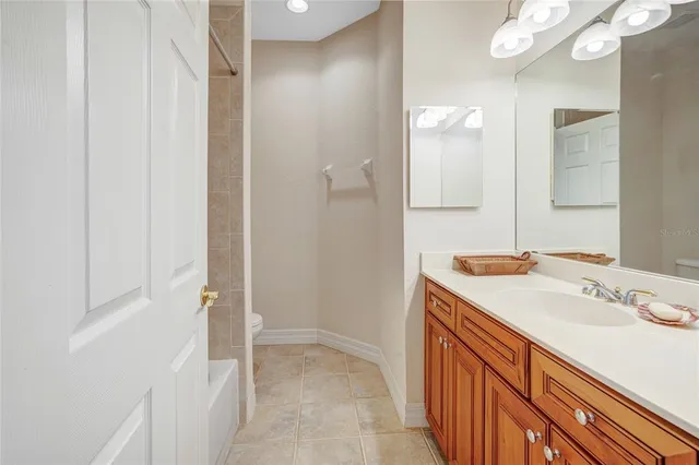a bedroom with a bed and a chandelier fan