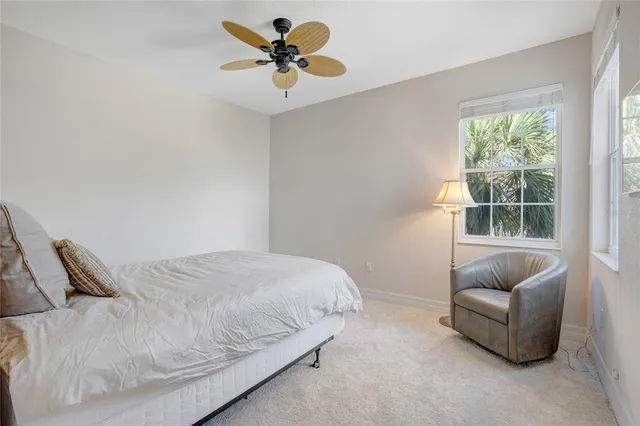 a dining room with furniture and a floor to ceiling window