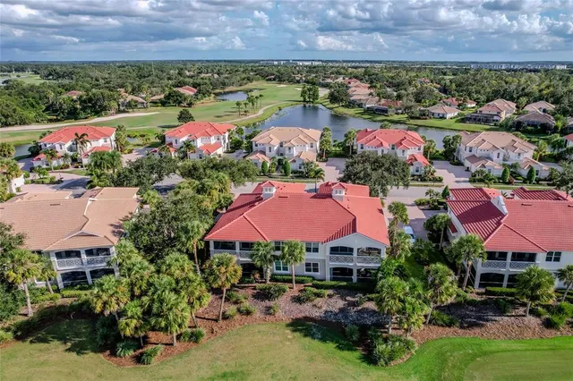 an aerial view of a houses with a lake view