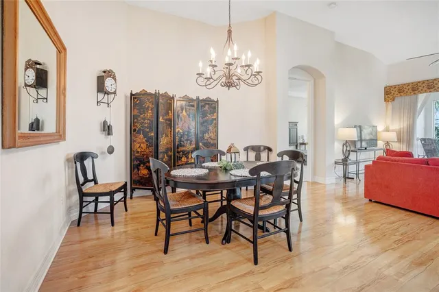 a view of a dining room with furniture wooden floor and chandelier
