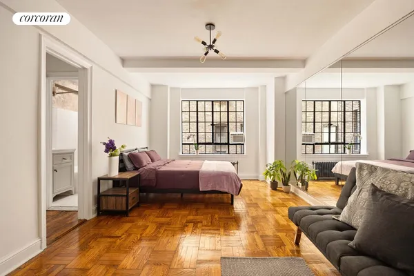 a spacious bedroom with a bed and a couch