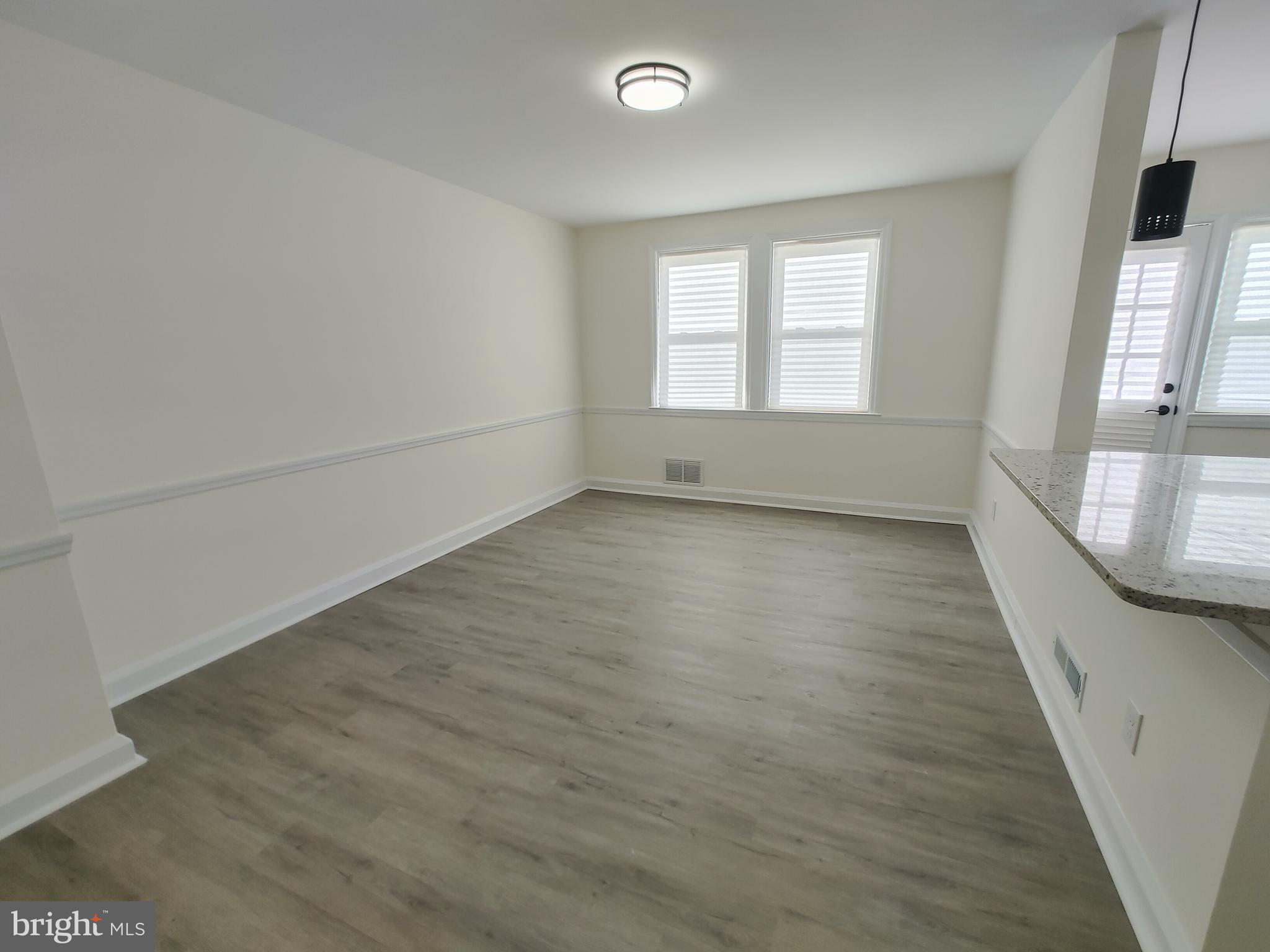 1525 Medford Road Baltimore, MD 21218 - Photo 11 of 39 wooden floor in an empty room with a window