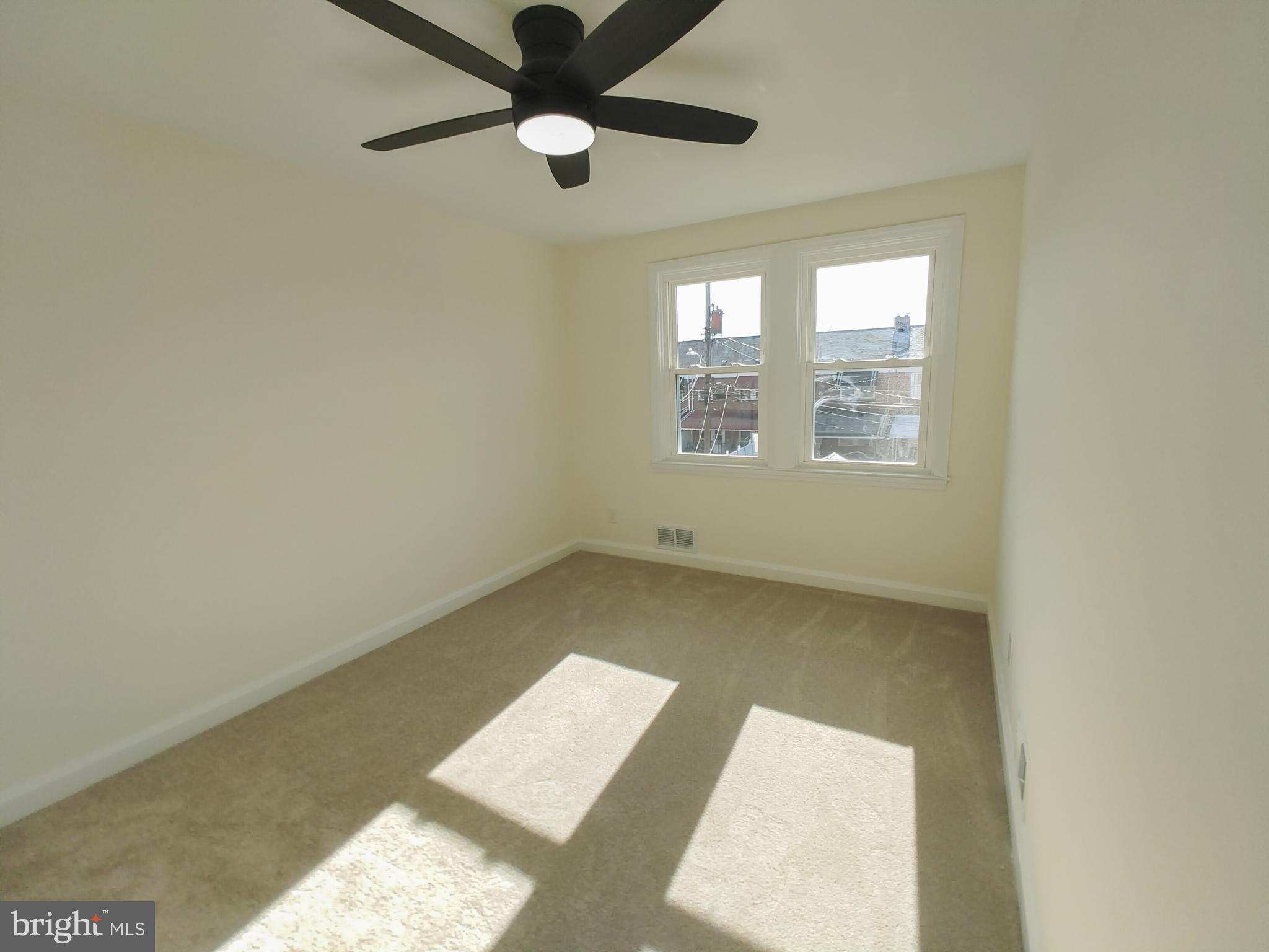 1525 Medford Road Baltimore, MD 21218 - Photo 26 of 39 an empty room with a window and a ceiling fan