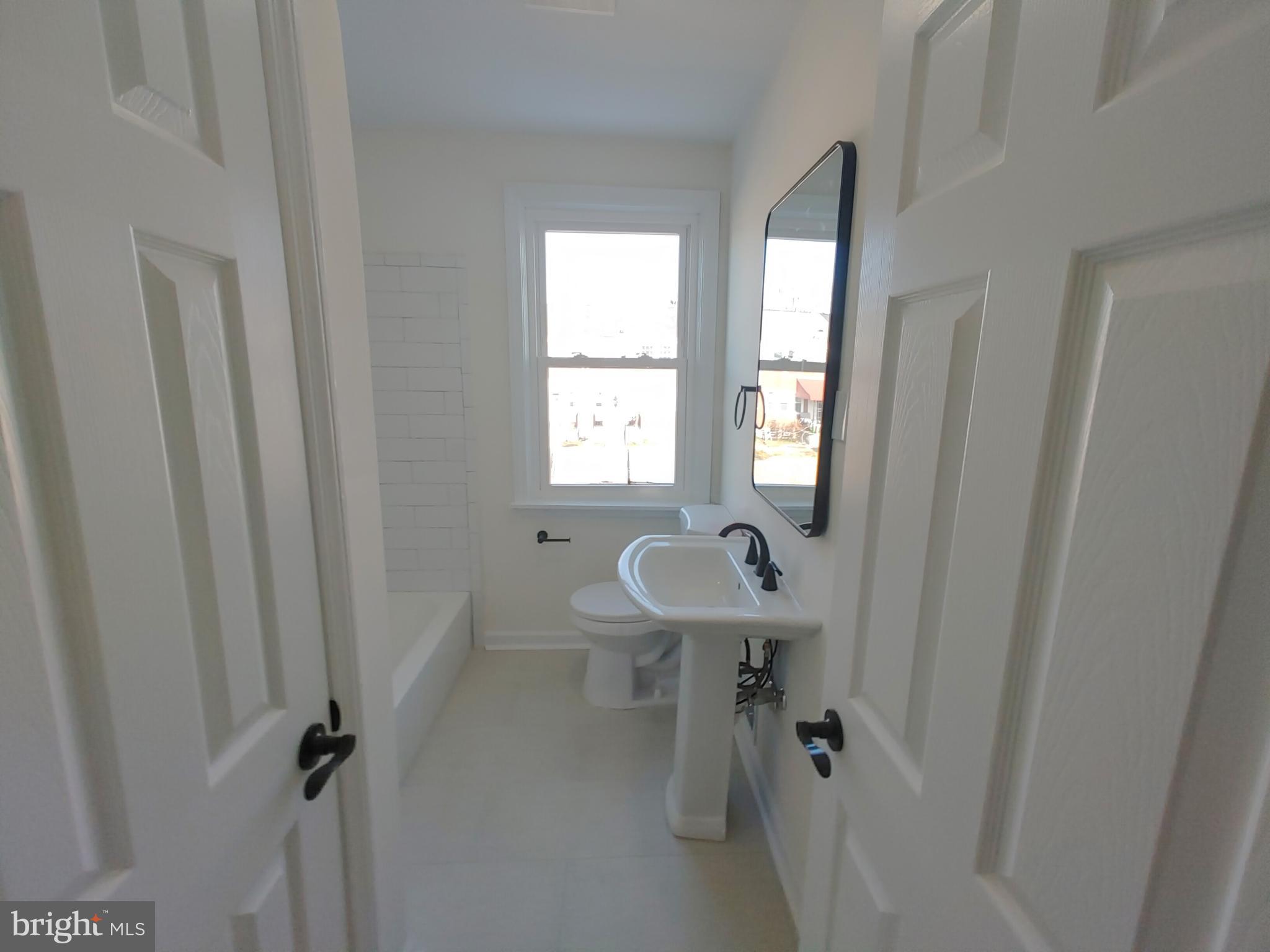1525 Medford Road Baltimore, MD 21218 - Photo 28 of 39 a bathroom with a sink toilet and shower