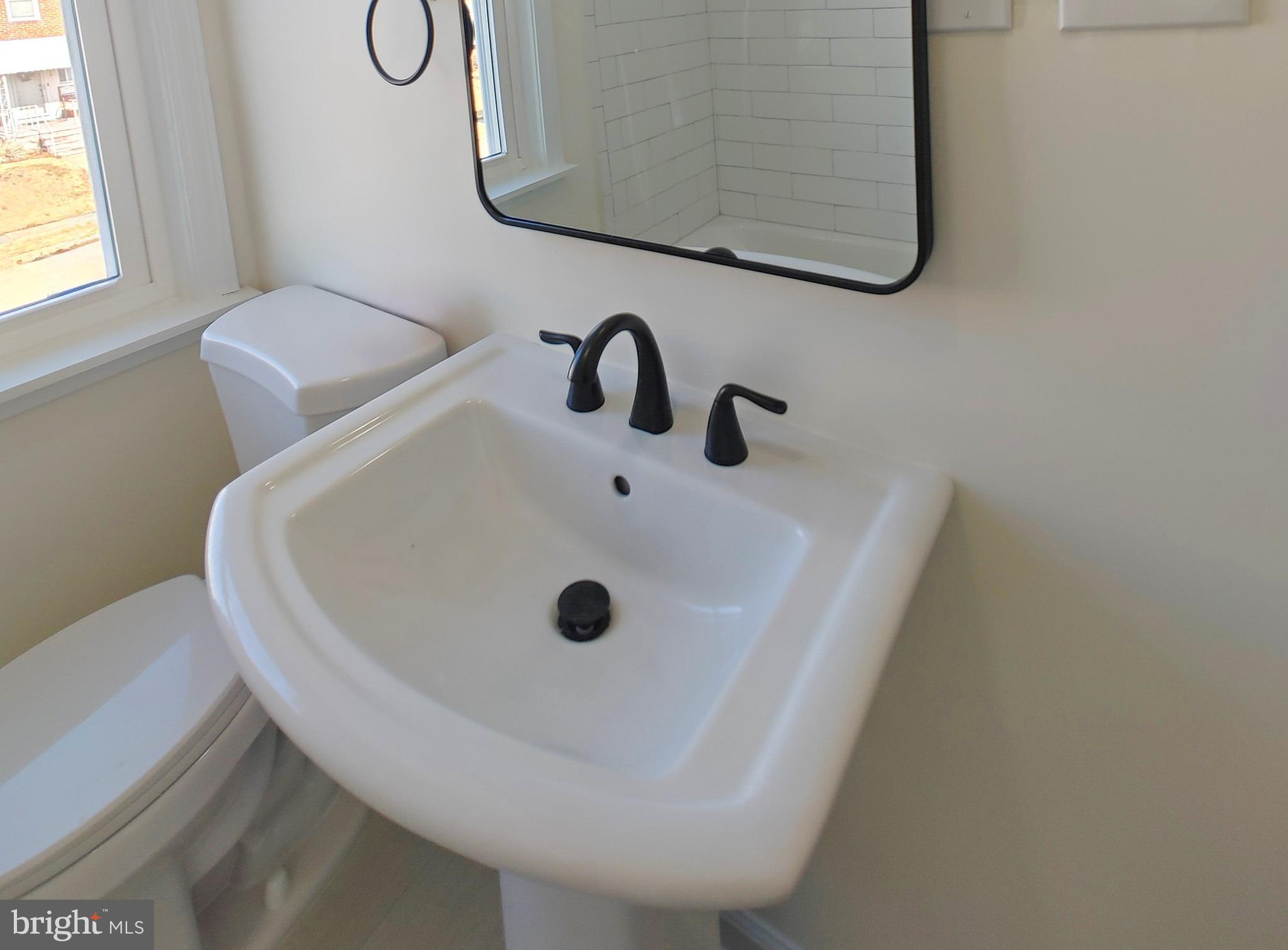 1525 Medford Road Baltimore, MD 21218 - Photo 30 of 39 a bathroom with a sink and a window