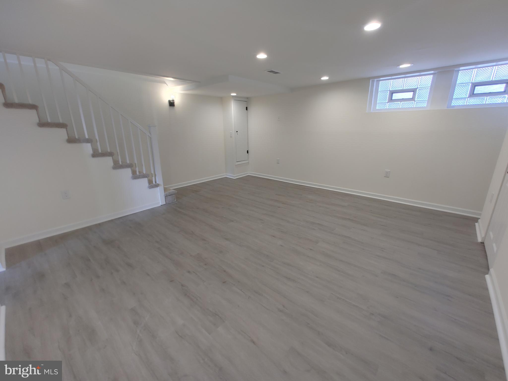 1525 Medford Road Baltimore, MD 21218 - Photo 32 of 39 an empty room with wooden floor and windows