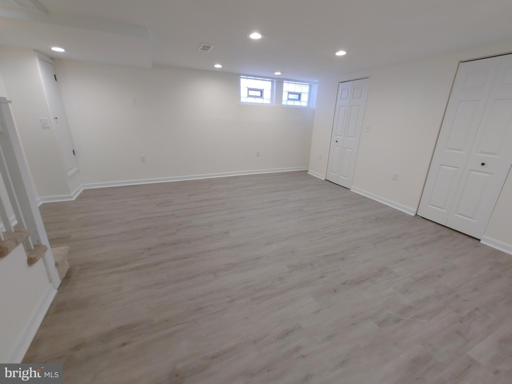 1525 Medford Road Baltimore, MD 21218 - Photo 33 of 39 an empty room with wooden floor and windows