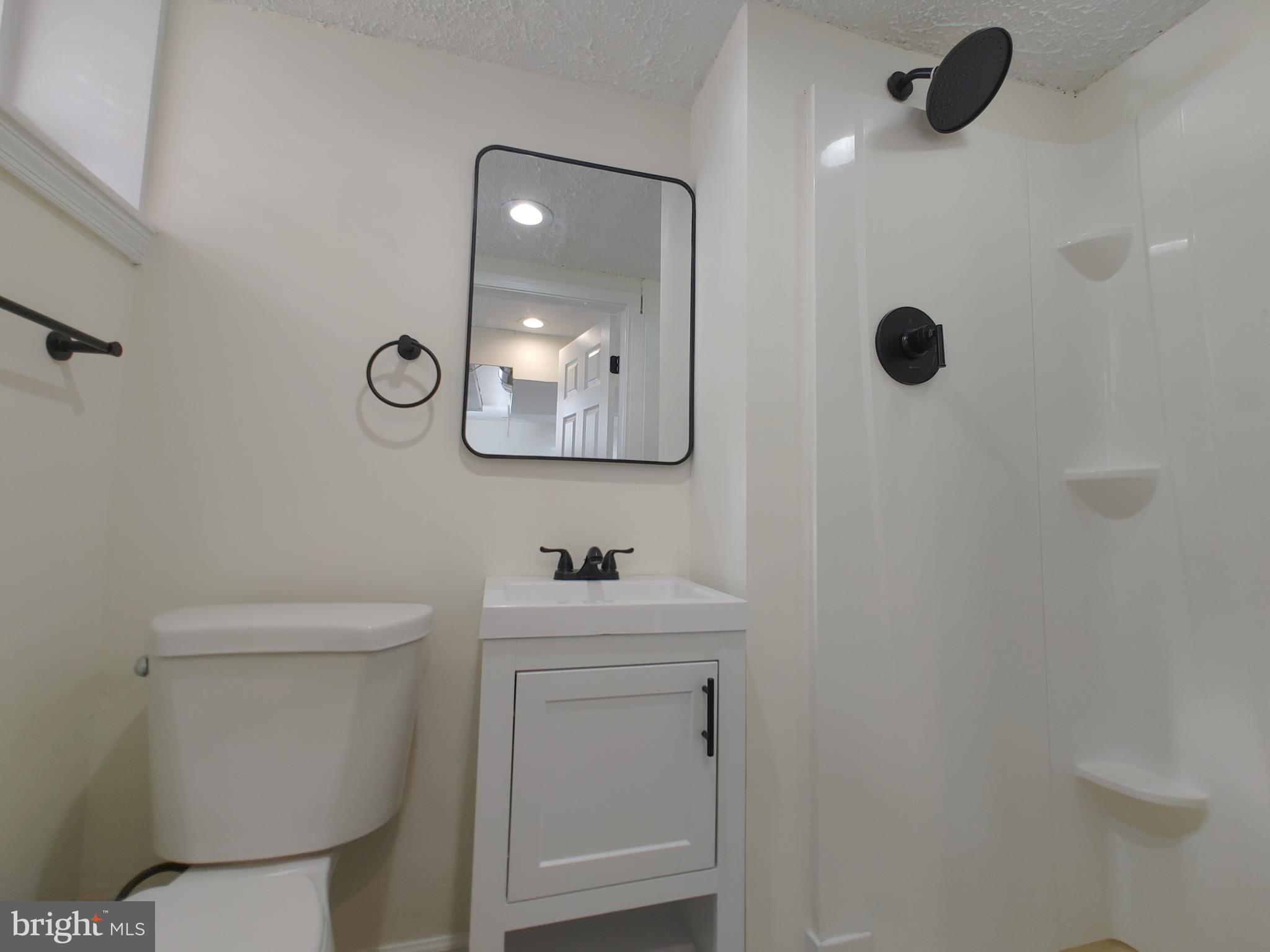1525 Medford Road Baltimore, MD 21218 - Photo 39 of 39 a bathroom with a toilet sink and mirror