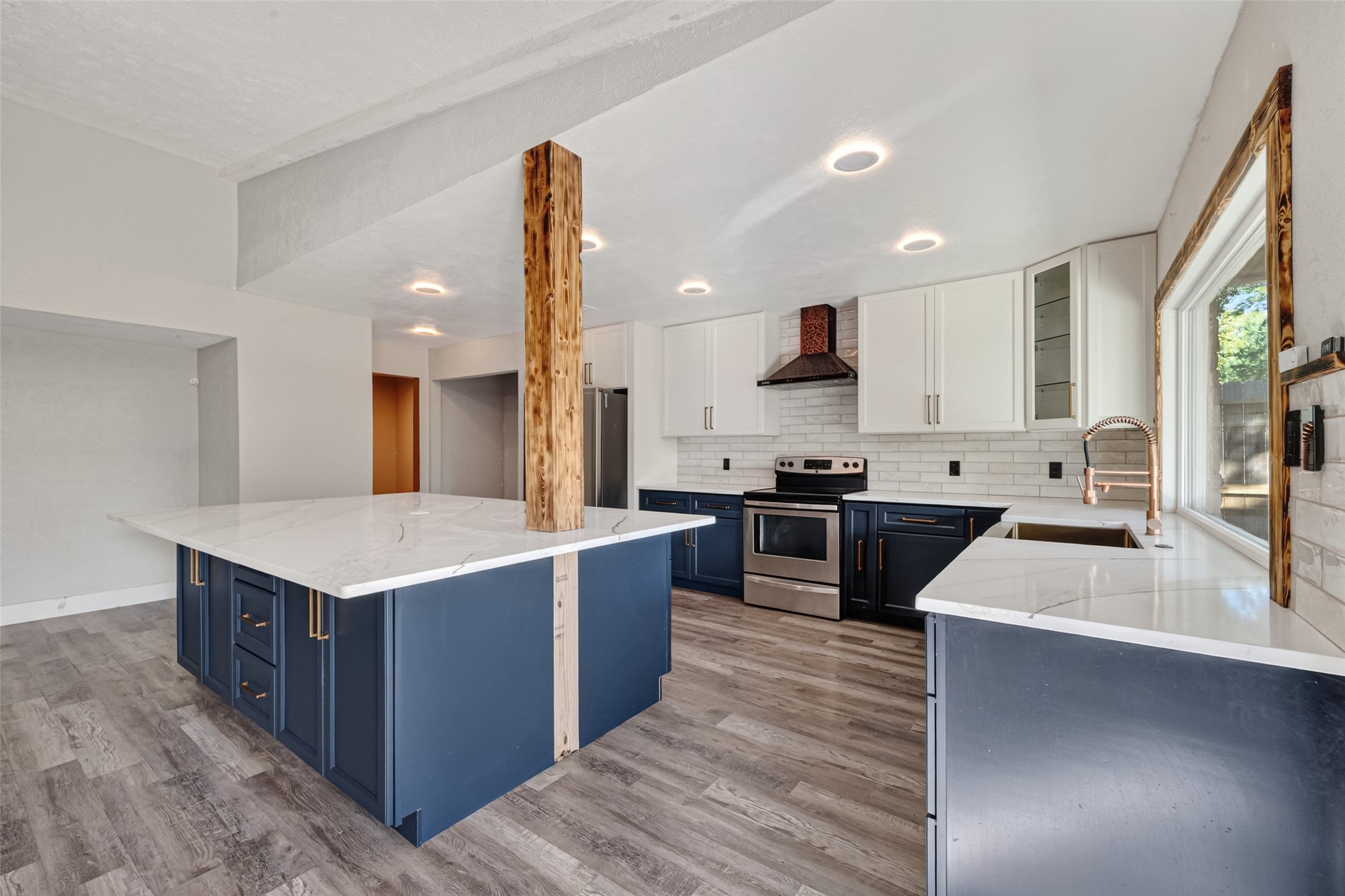 a kitchen with stainless steel appliances kitchen island a large counter top and a stove