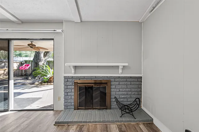 a living room with a fireplace and a floor to ceiling window