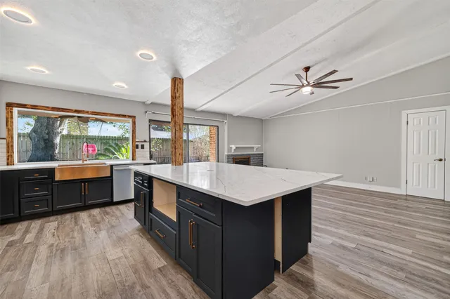 a kitchen with a stove a sink and a refrigerator