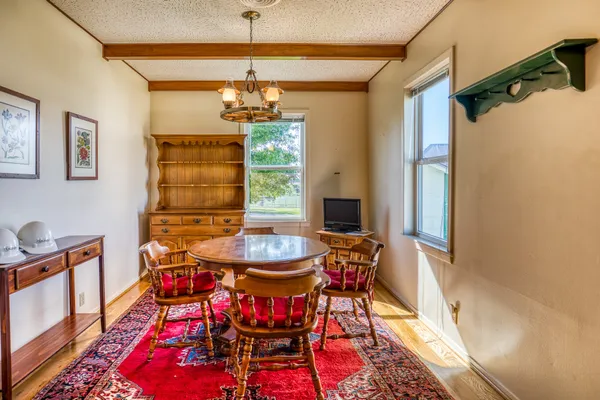 a view of a dining room with furniture and chandelier