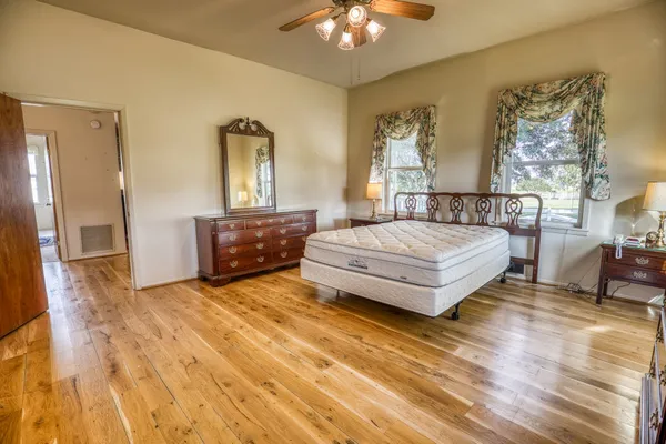 a bedroom with a bed and a chandelier