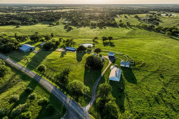 a view of a town with lush green forest