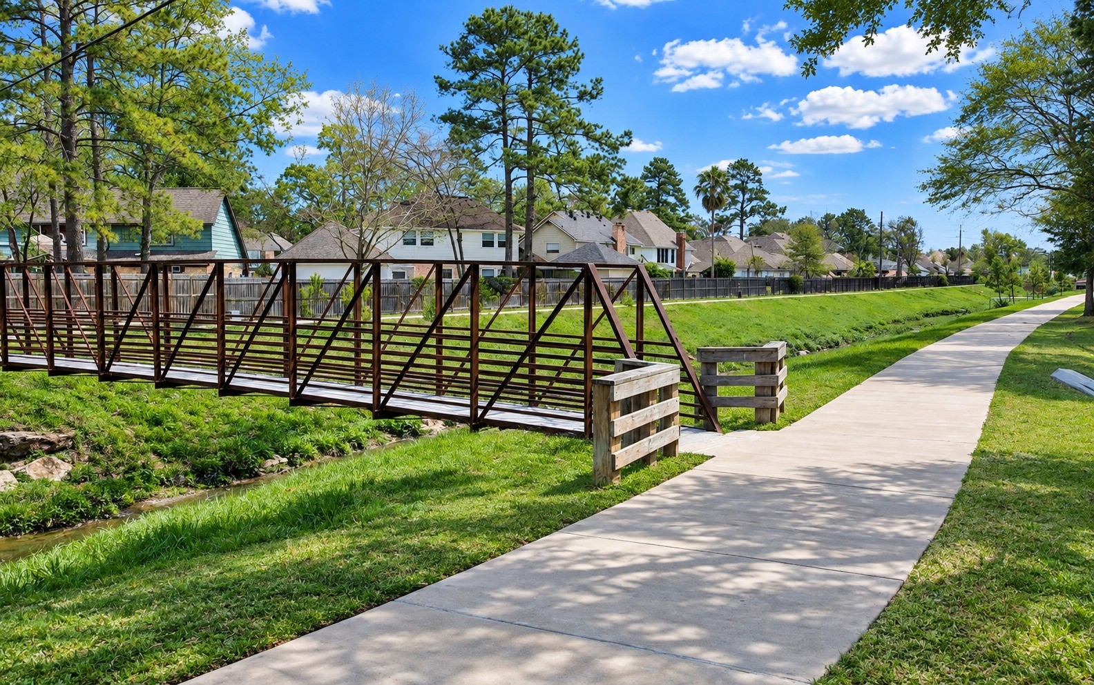 17523 Spicewood Springs Lane Spring, TX 77379 - Photo 42 of 42 Enjoy miles of scenic walking trails that connect multiple surrounding neighborhoods, offering a beautiful setting for walking, jogging, biking, or simply enjoying the outdoors. Along the trail, cross the neighborhood favorite known as the “Turtle Bridge,” where turtles can often be spotted in the creek below—a charming feature that makes this community trail especially memorable. Resting benches are nearby.