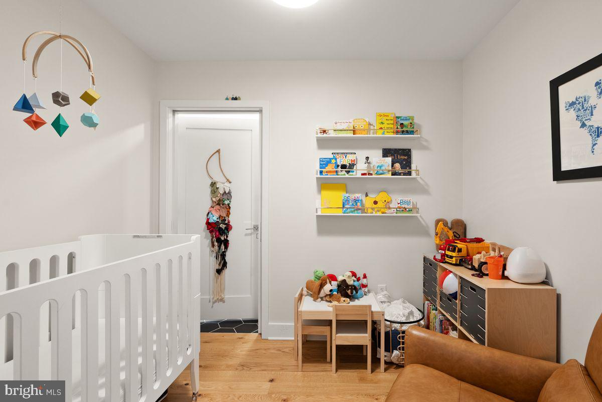 1211 Van Street Southeast, Unit PH13B Washington, DC 20003 - Photo 16 of 25 a living room with furniture and baby crib