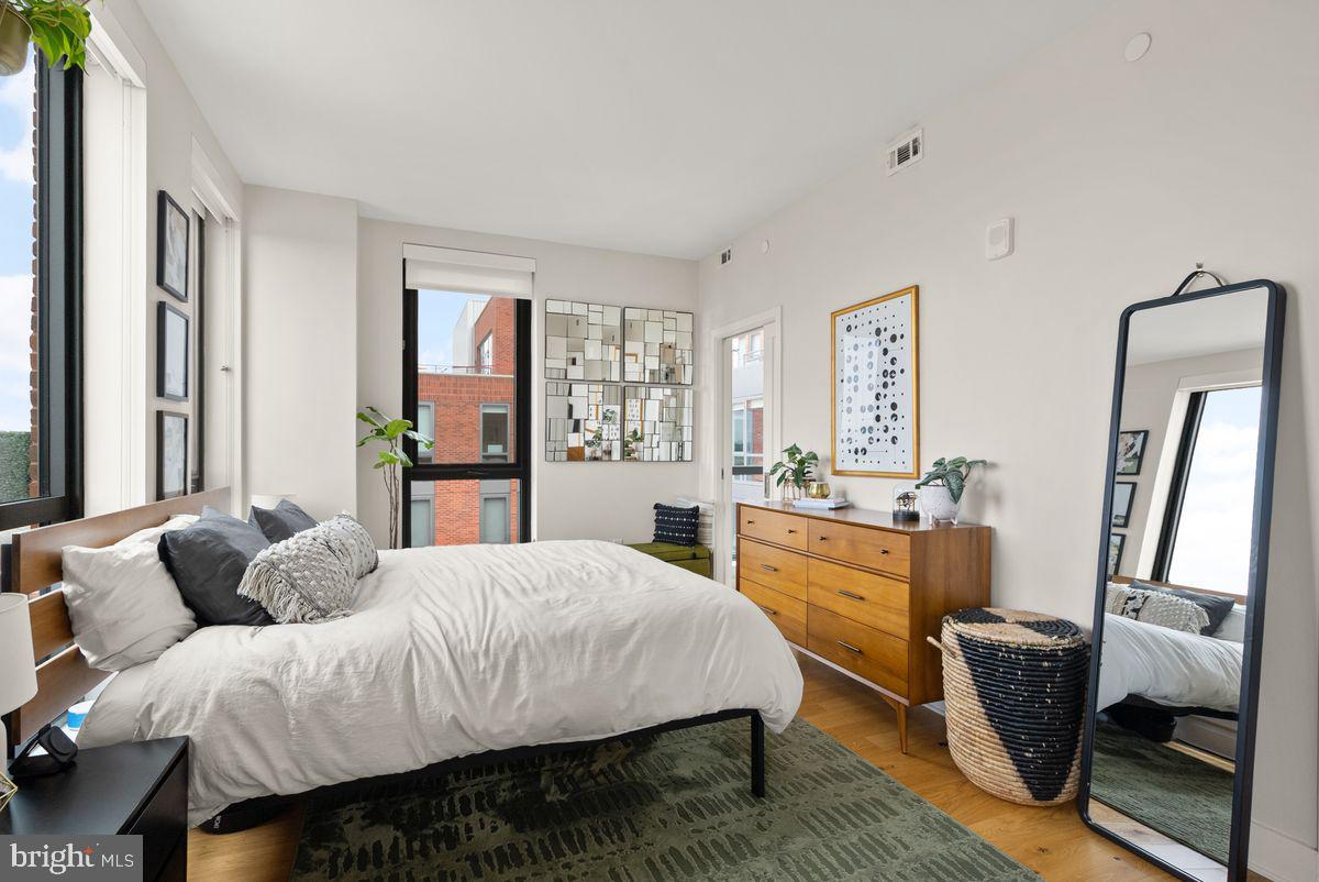 1211 Van Street Southeast, Unit PH13B Washington, DC 20003 - Photo 17 of 25 a bedroom with a bed a couch and dresser