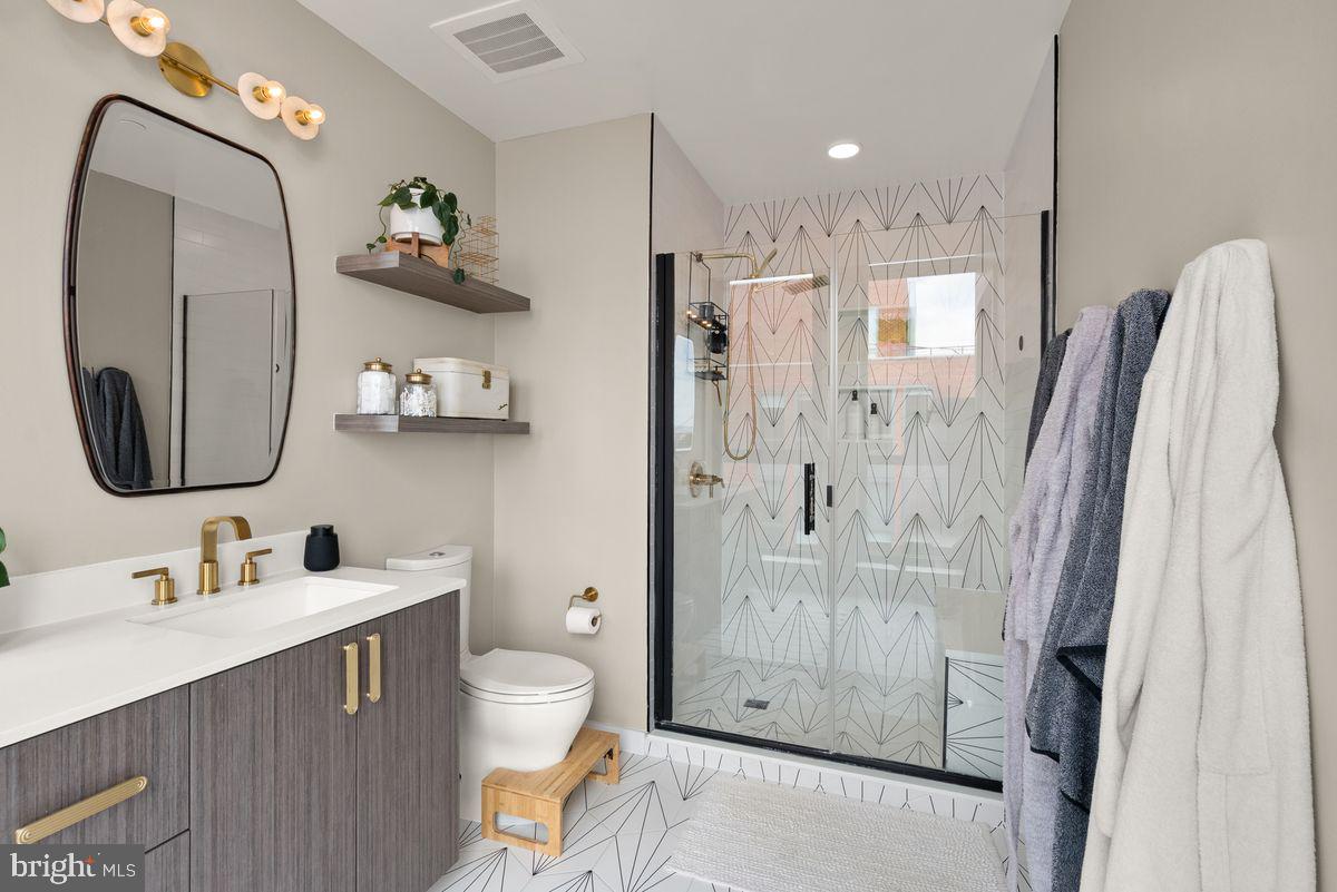 1211 Van Street Southeast, Unit PH13B Washington, DC 20003 - Photo 18 of 25 a bathroom with a sink a toilet and shower