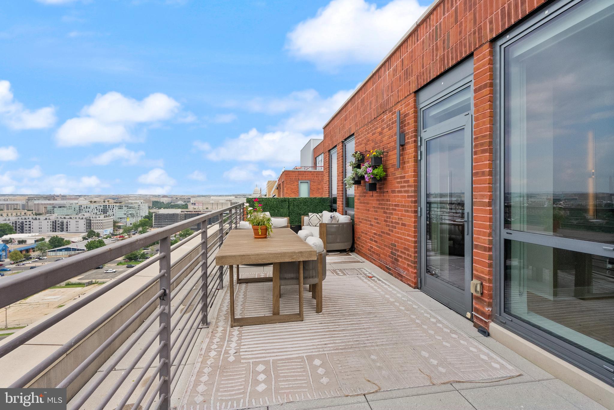 1211 Van Street Southeast, Unit PH13B Washington, DC 20003 - Photo 20 of 25 a view of city from a balcony with seating space
