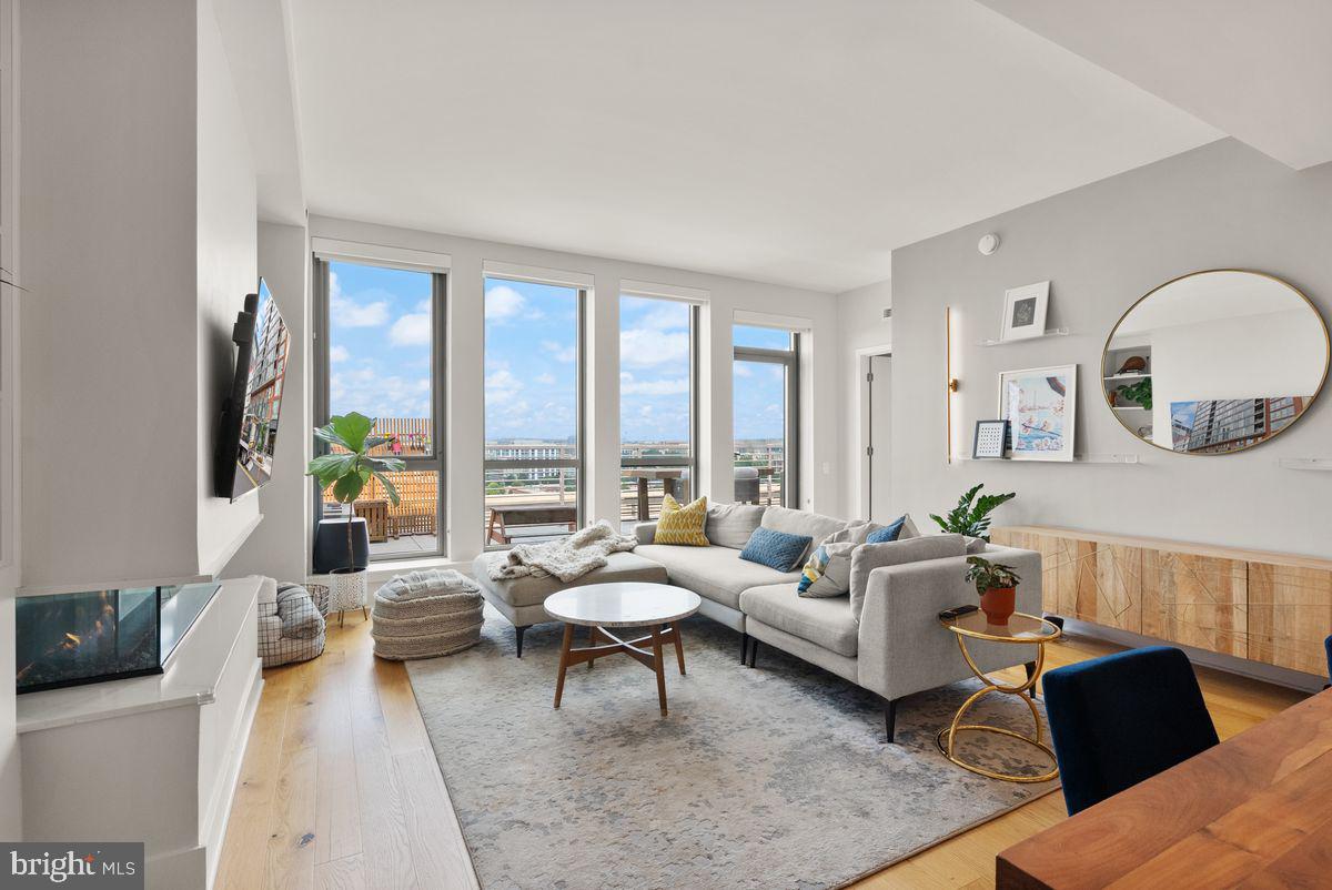 1211 Van Street Southeast, Unit PH13B Washington, DC 20003 - Photo 10 of 25 a living room with furniture and a large window