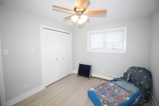a view of workspace with window and a chandelier fan