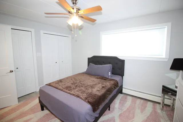 a bedroom with a bed and a window