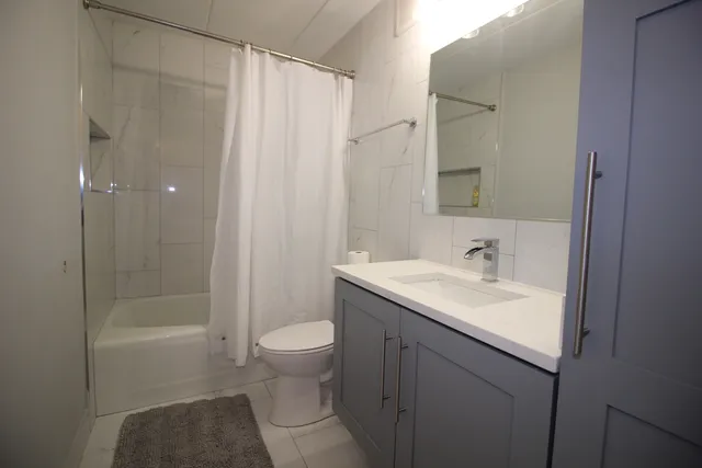 a bathroom with a sink toilet and shower