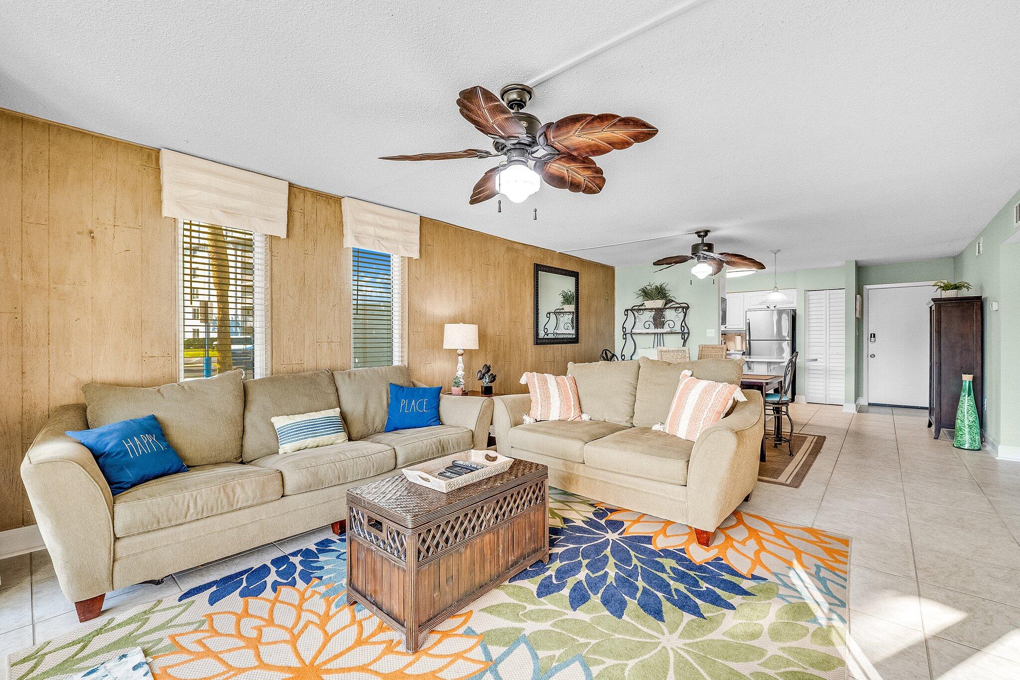 30 Moreno Point Road, Unit 106C Destin, FL 32541 - Photo 13 of 37 a living room with furniture and a large window