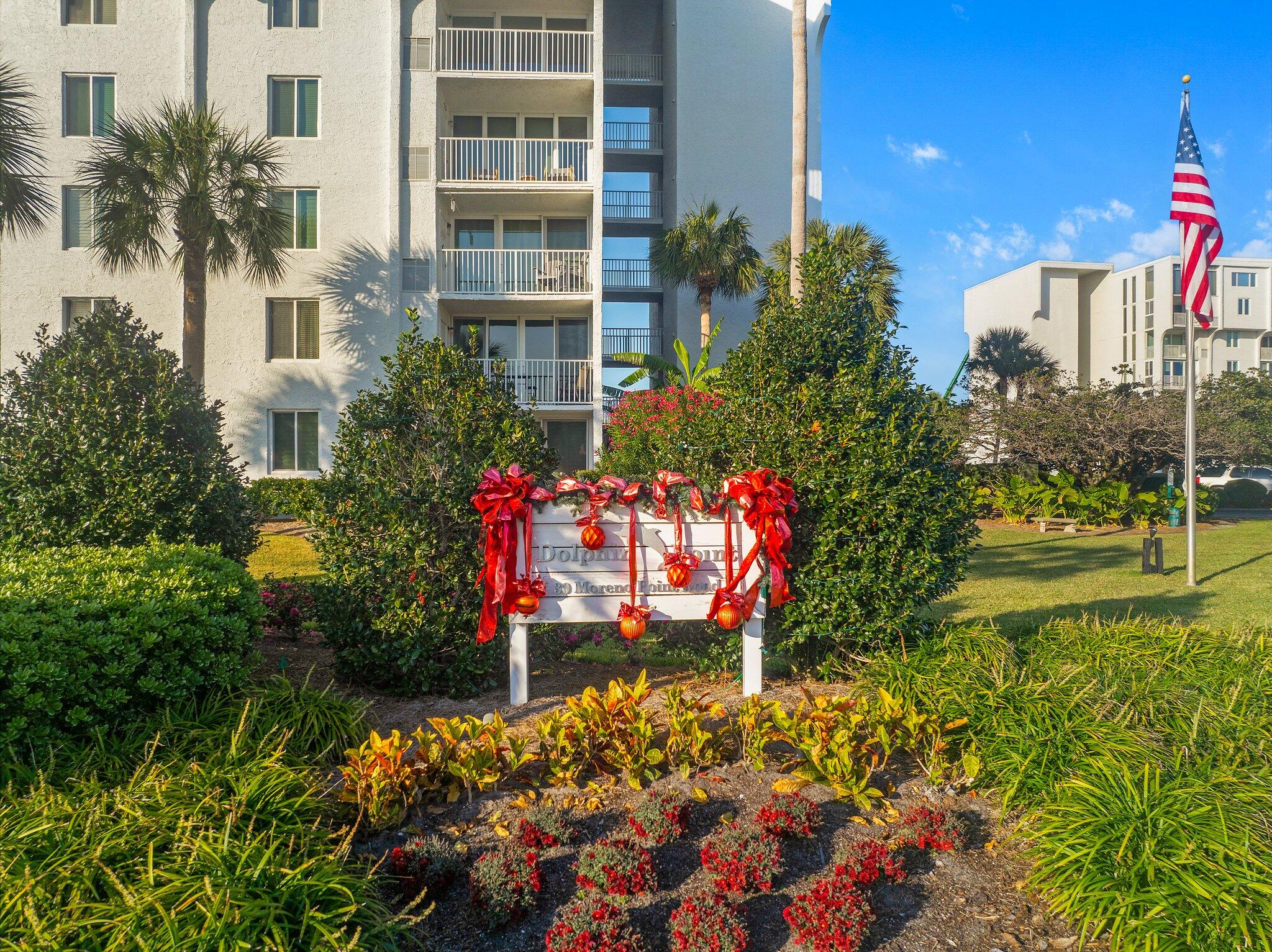 30 Moreno Point Road, Unit 106C Destin, FL 32541 - Photo 36 of 37 front view of a multi story building with a yard and potted plants