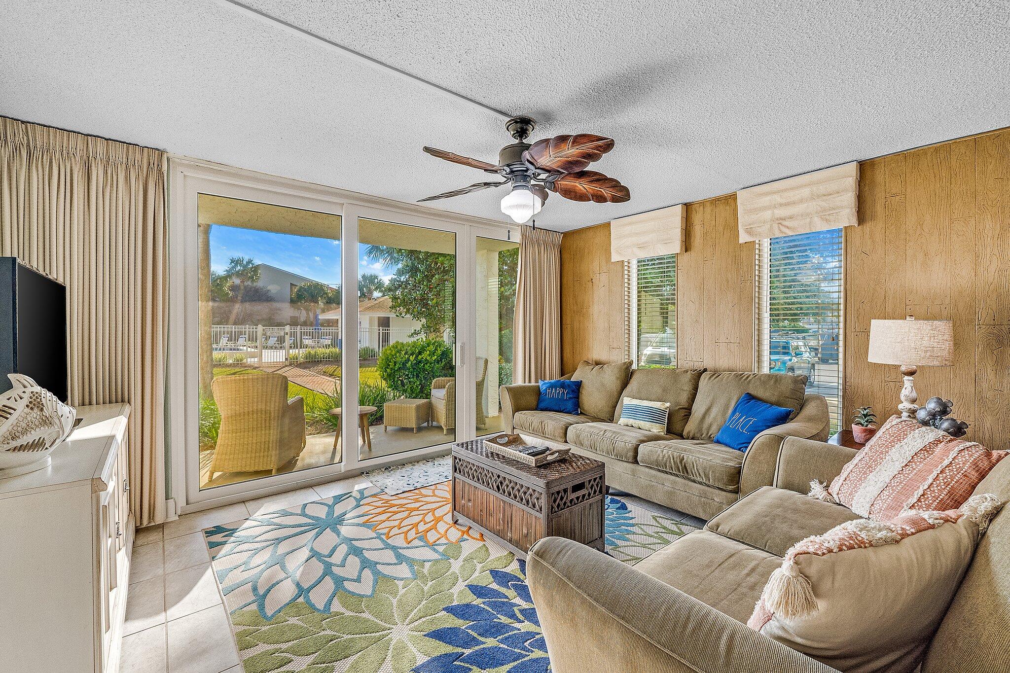 30 Moreno Point Road, Unit 106C Destin, FL 32541 - Photo 10 of 37 a living room with furniture and a flat screen tv