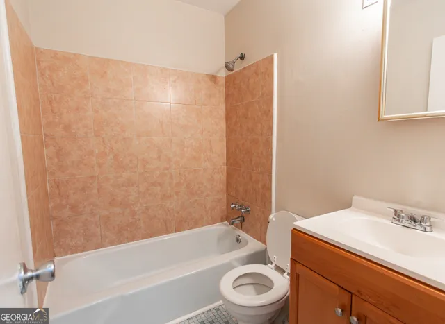 a bathroom with a sink a toilet and bathtub