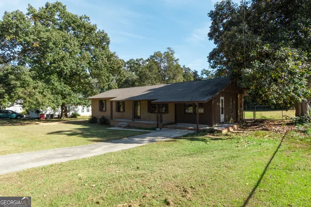a house that has a big yard with large trees