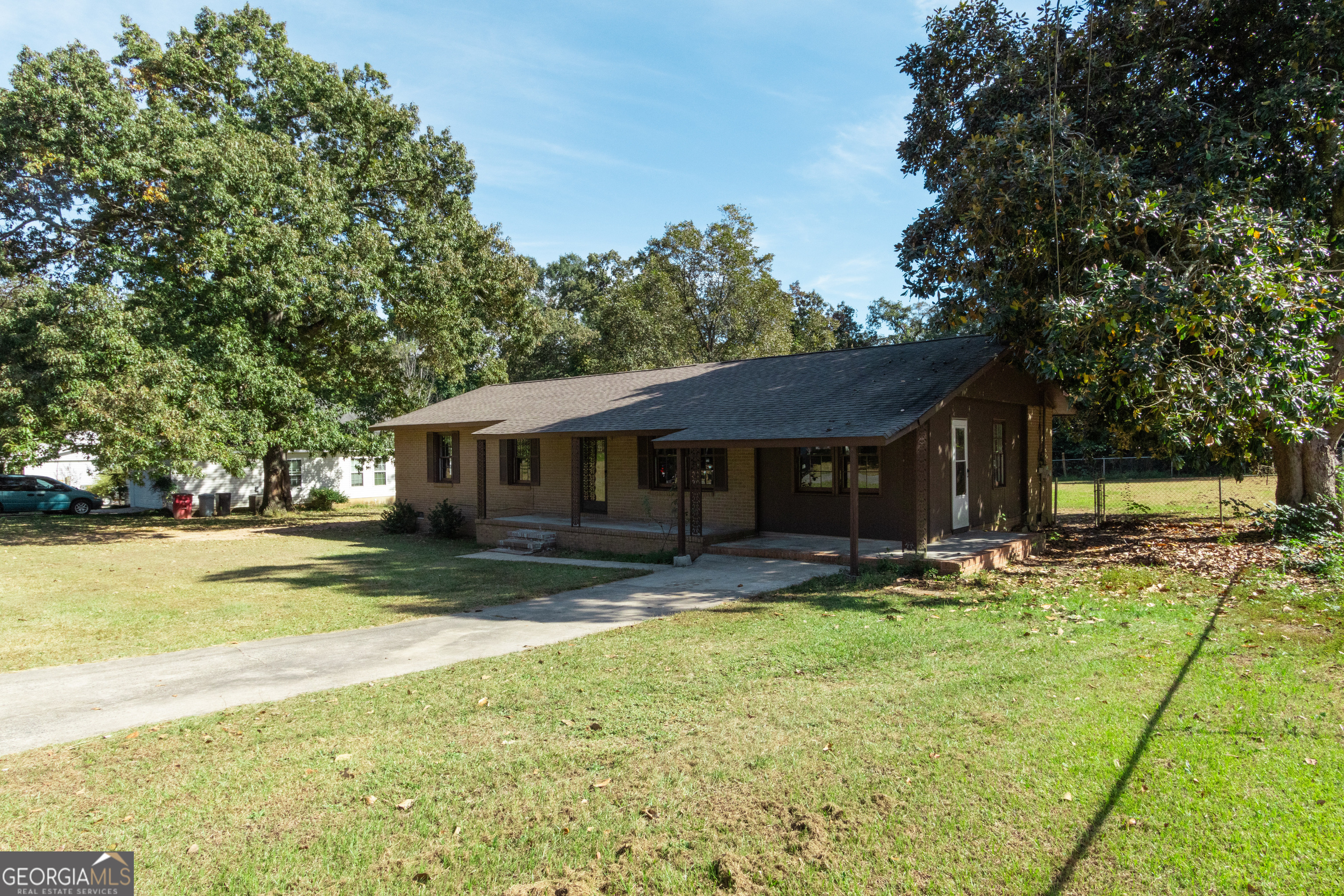 208 Bassett Street Centerville, GA 31028 - Photo 2 of 24 a house that has a big yard with large trees